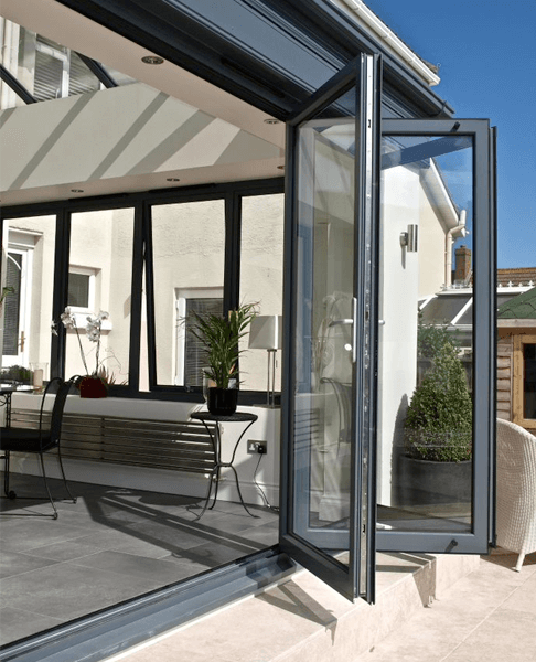 bi-fold doors opened dark navy uPVC