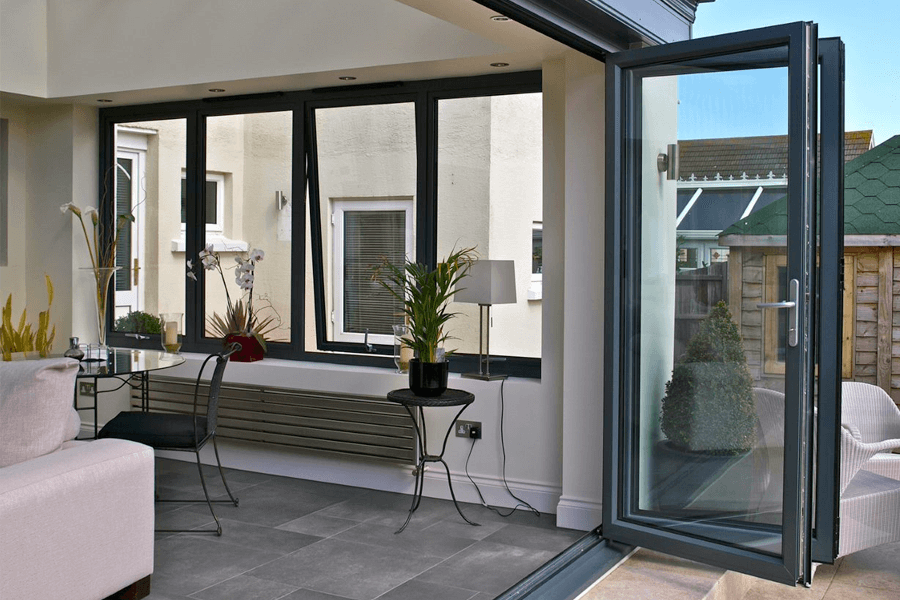 Dark navy uPVC bifolding doors opened to patio