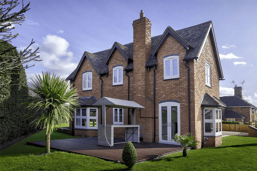 4 white uPVC flush casement windows on a tall house