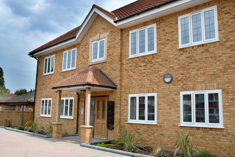 large house front with 9 casement white uPVC windows right angle close up